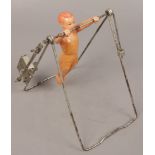 A vintage clockwork celluloid toy gymnast.