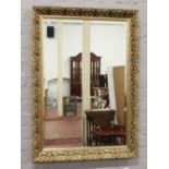 An ornate framed bevel edge wall mirror 58cm x 87cm.
