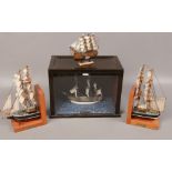Three model boats to include HMS Bounty in display case, wooden bookends 'Cutty Sark'.