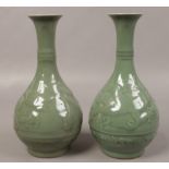 A pair of 19th century Chinese Celadon vases, decorated with dragons.