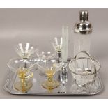 A collection of cocktail glasses with etched glass cocktail shaker on silver plated tray.