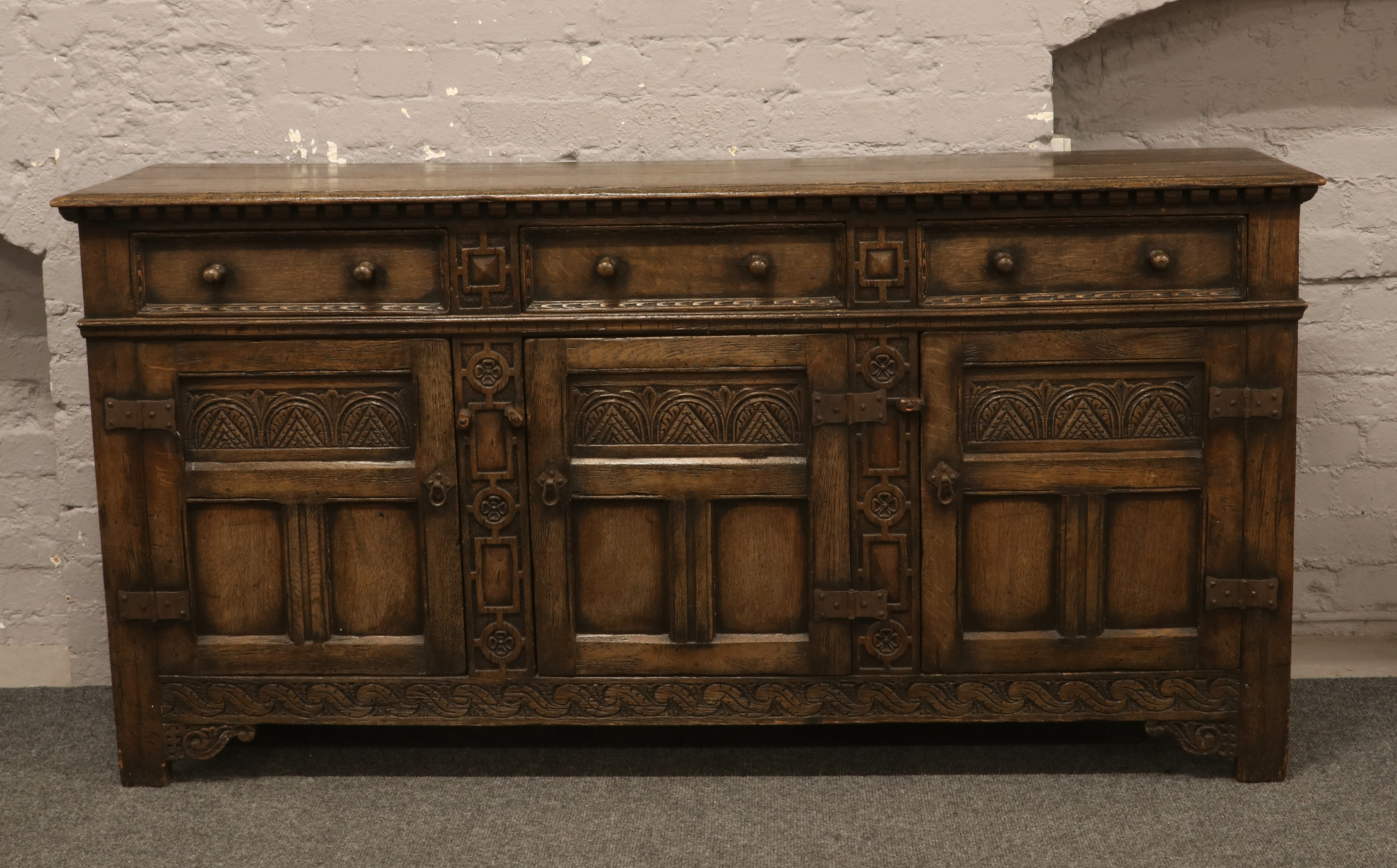 A carved and panelled oak dresser with three drawers, 183 x 92 x 49cm