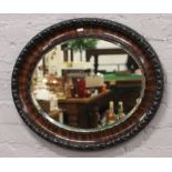 An oval mahogany bevel edge wall mirror 50cm x 40cm.