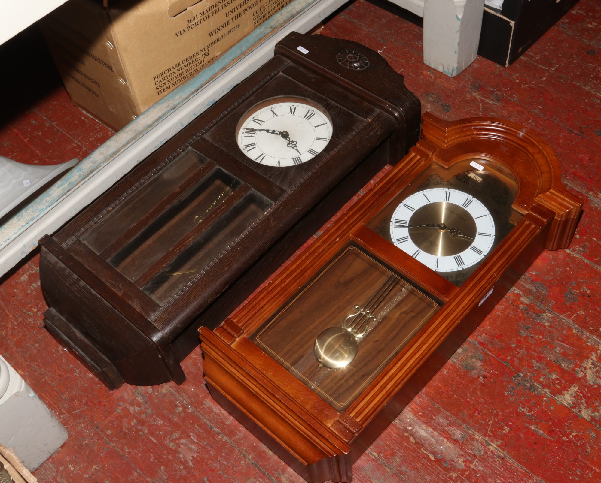 An Edwardian carved oak wall clock later altered to a quartz movement, along with a quartz