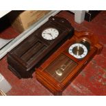 An Edwardian carved oak wall clock later altered to a quartz movement, along with a quartz