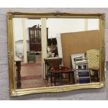 A large ornate gilt framed bevel edge wall mirror 116cm x 88cm.