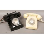 A black bakelite vintage dial telephone and a cream vintage BT GPO 746 rotary dial telephone.