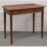 A mahogany two drawer side table raised on square tapering legs.