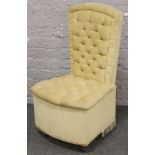A deep button upholstered bedroom chair.