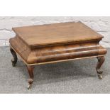 A Walnut ogee shape footstool with drawer raised on small cabriole legs.