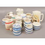 A collection of ceramics to include Wade, Cornish ware advertising jugs etc.