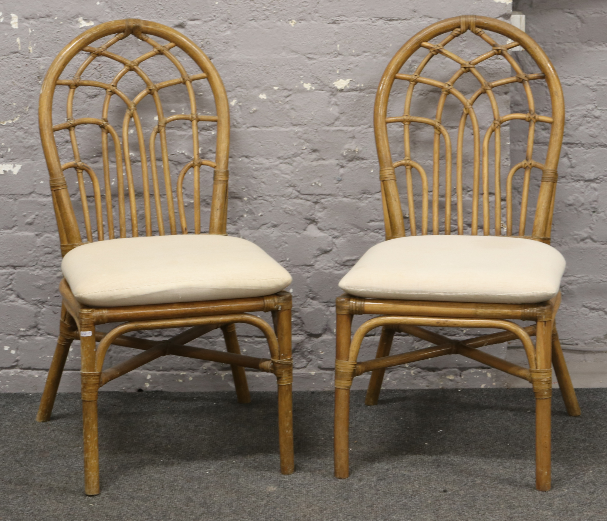 Two bamboo effect conservatory chairs.