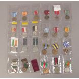 A collection of twenty five medals and ribbons including Police, Swiss Shooting etc.