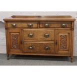 A Victorian mahogany sideboard with carved decoration.