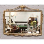 An ornate gilt framed wall mirror, 80cm x 100cm.