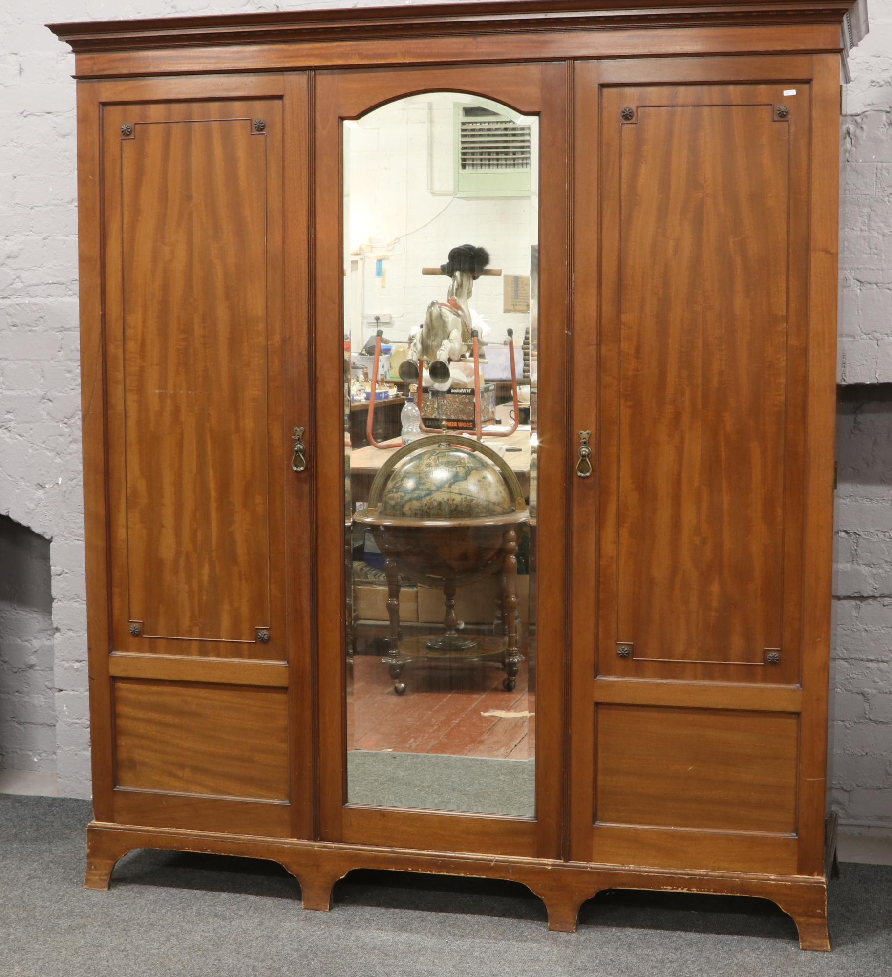 An Edwardian mahogany triple wardrobe / linen press.