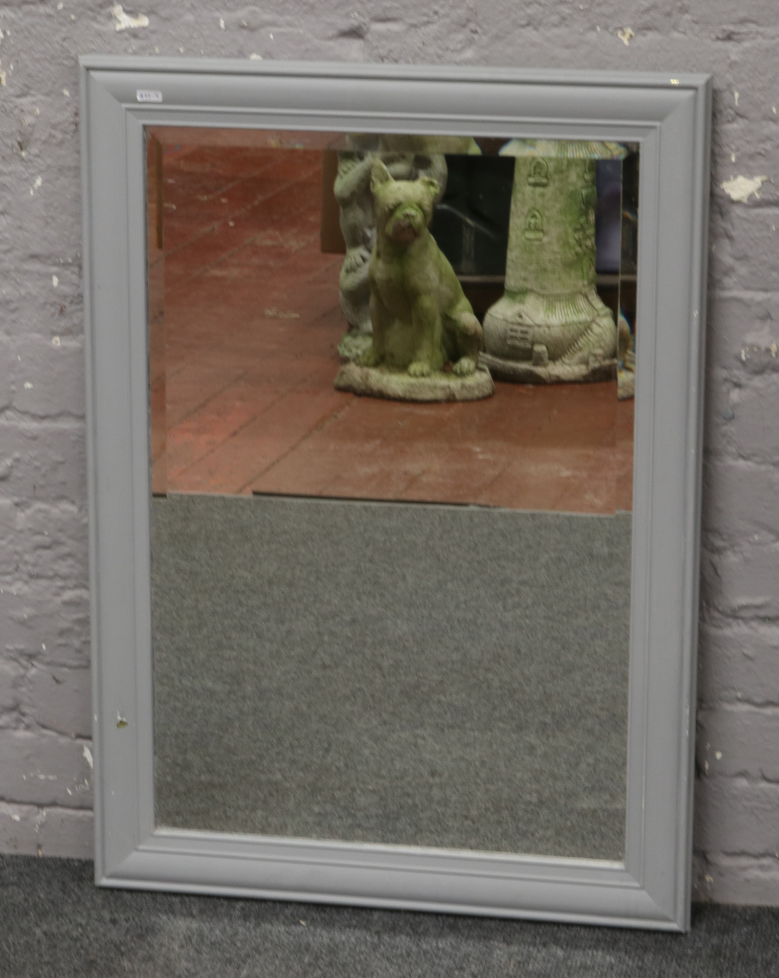 A bevel edged wall mirror in grey painted frame, 88cm x 63cm.