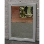 A bevel edged wall mirror in grey painted frame, 88cm x 63cm.