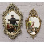 Two ornate gilt framed wall mirrors.