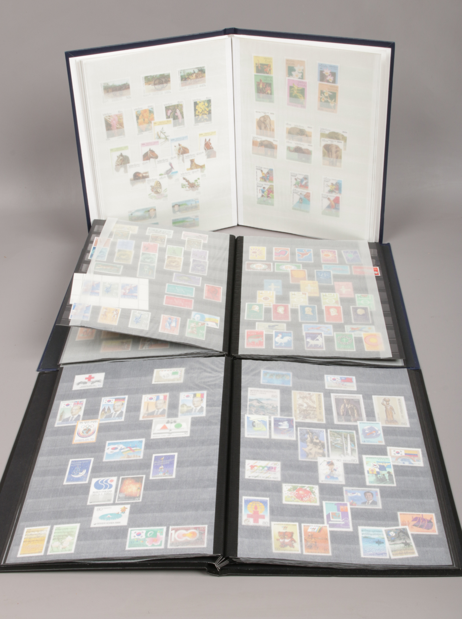 Three albums of stamps from around the world.