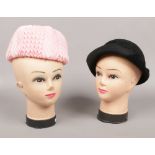 Two vintage shop mannequin heads.