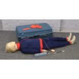 A cased CPR training manikin. Recording Resusci Anne, makers Asbond S. Laerdal medical.