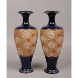 A pair of blue ground Royal Doulton Slater patent stoneware vases with moulded decoration.