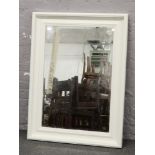 A large white painted framed bevel edge wall mirror 118cm x 87cm.