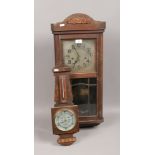 An Edwardian oak wall clock, along with a small oak barometer.