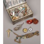 A box of costume jewellery and collectables including filigree spray brooch, enameled badges,