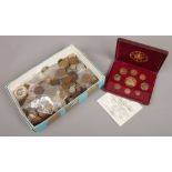 A box of mixed British and foreign coins to include commemorative examples and a cased United