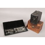 A cased set of Temple drawing instruments and a Kodak Box 620 camera in crocodile effect case.