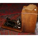 A cased Frister & Rossmann German hand crank sewing machine.