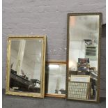 Three gilt framed wall mirrors.