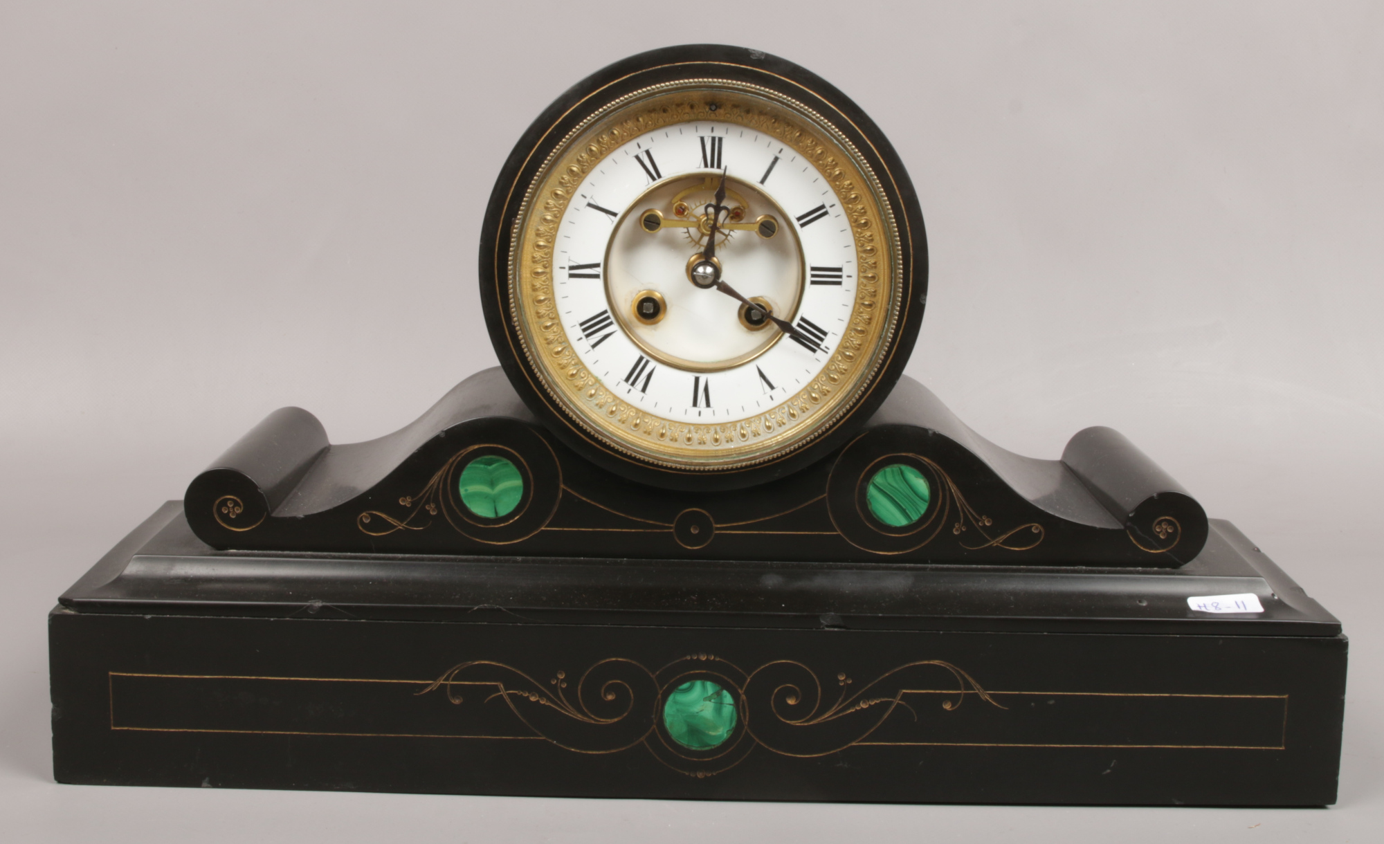 A Victorian slate mantle clock with visible anchor escapement and malachite decoration.