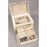 A modern four tier jewellery box and assorted costume jewellery including rings and ladies dress