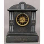 A large black slate mantel clock with ornate brass dial, 50cm x 40cm.