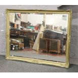 A large gilt framed bevel edge wall mirror, 136cm x 105cm.
