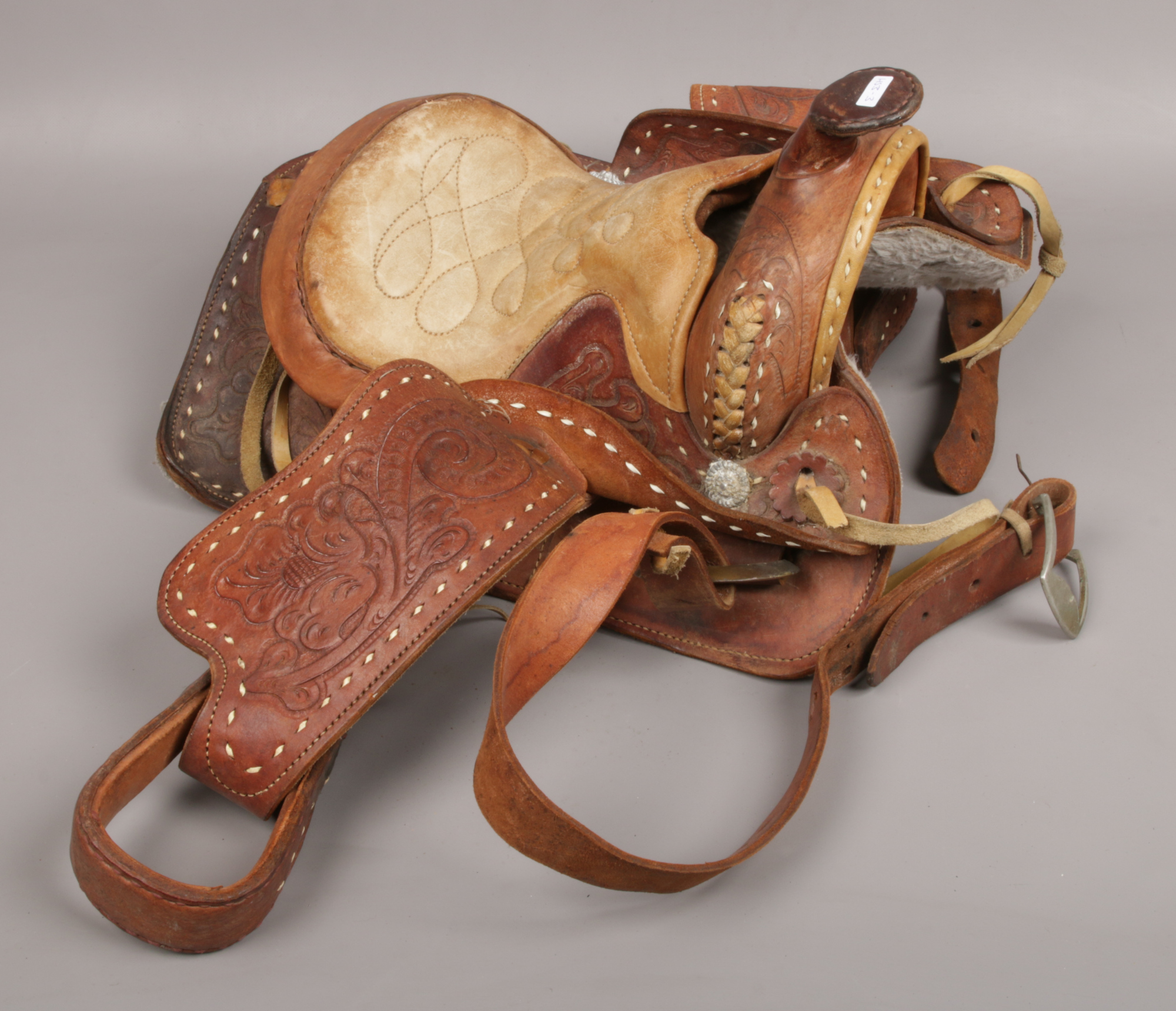 A tooled leather western horse saddle.