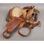 A tooled leather western horse saddle.