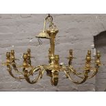 A gilt metal ten branch chandelier with double scrolling branches supporting rococo style sconces.