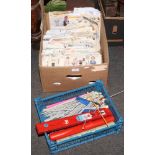 A box of sewing and knitting related to include patterns and needles.