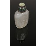A late 19th century Chinese carved rock crystal snuff bottle with jadeite stopper. Well hollowed and