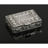A silver snuff box with hinged cover and chased with roses. London import marks.