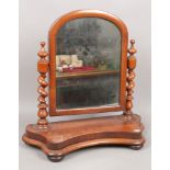 A Victorian mahogany toilet mirror with barleytwist supports.