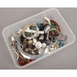 A box of dress jewellery including bangles, beads, blue paste heart pendant, dress watches etc.