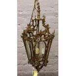 A brass and cut glass ornate lantern light fitting.