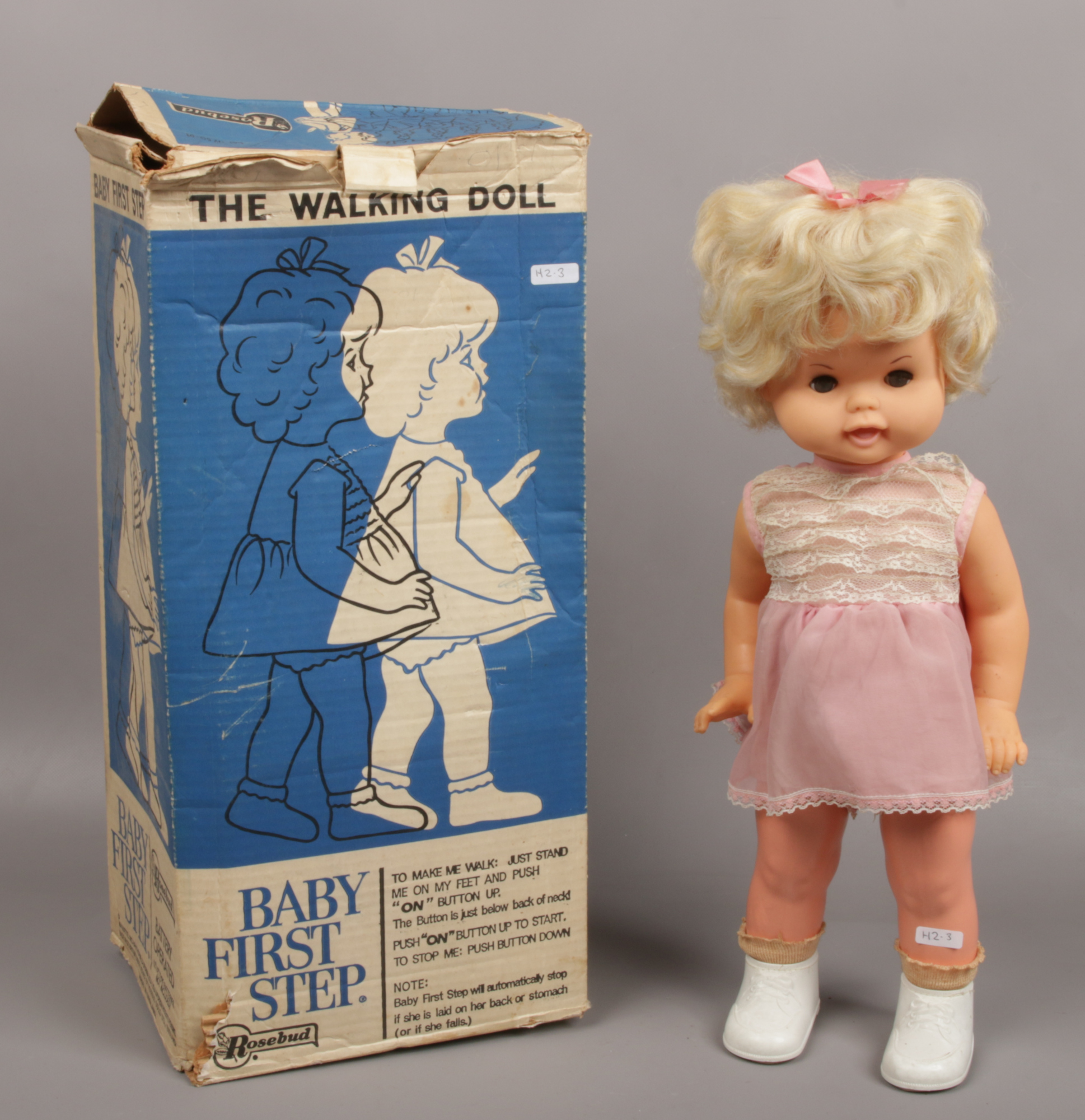 A 1960s battery powered baby first steps doll in original box by Rosebud Mattel.