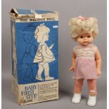 A 1960s battery powered baby first steps doll in original box by Rosebud Mattel.