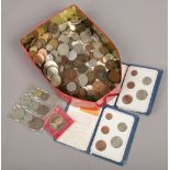 A tin of assorted coins including American and British pre decimal.